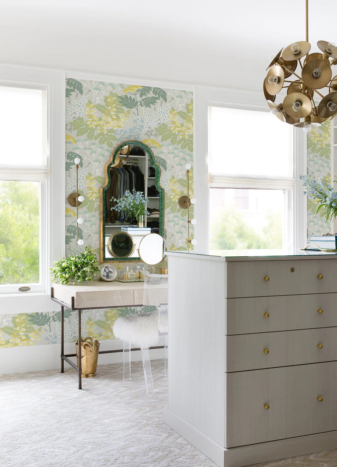 Floral wallpaper in a bright dressing area with a mirror and dresser