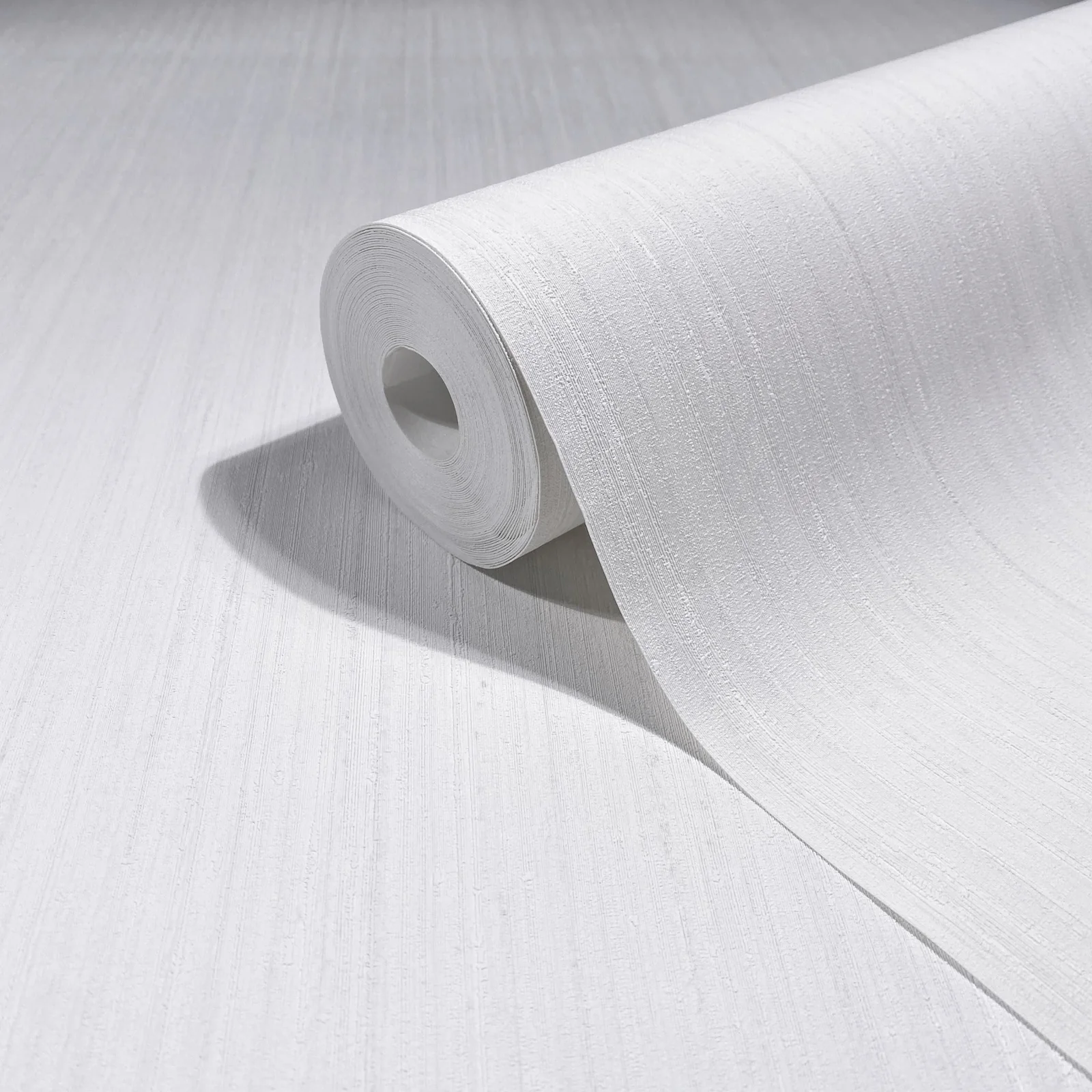 Indra Striated wallpaper roll showing a light linear texture